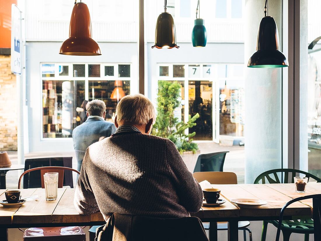 An older man reading a newspaper