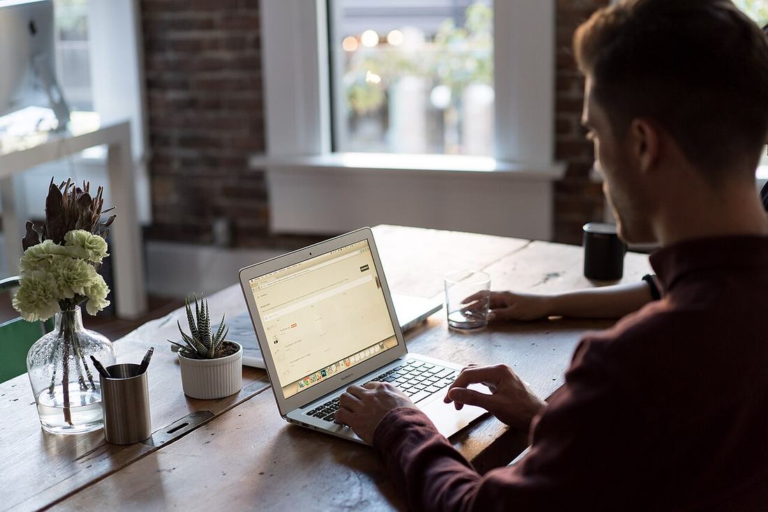 A man at a laptop in an office