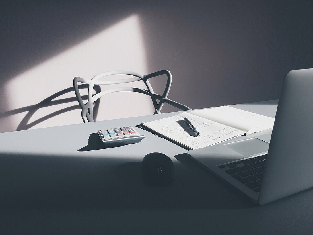 A laptop and calculator on a desk
